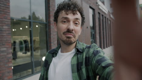 man taking selfie in front of store