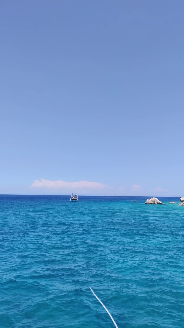 A red flag with a star on it is flying over the water