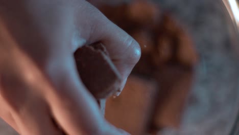 top down shot of a hand making cookie crumbles