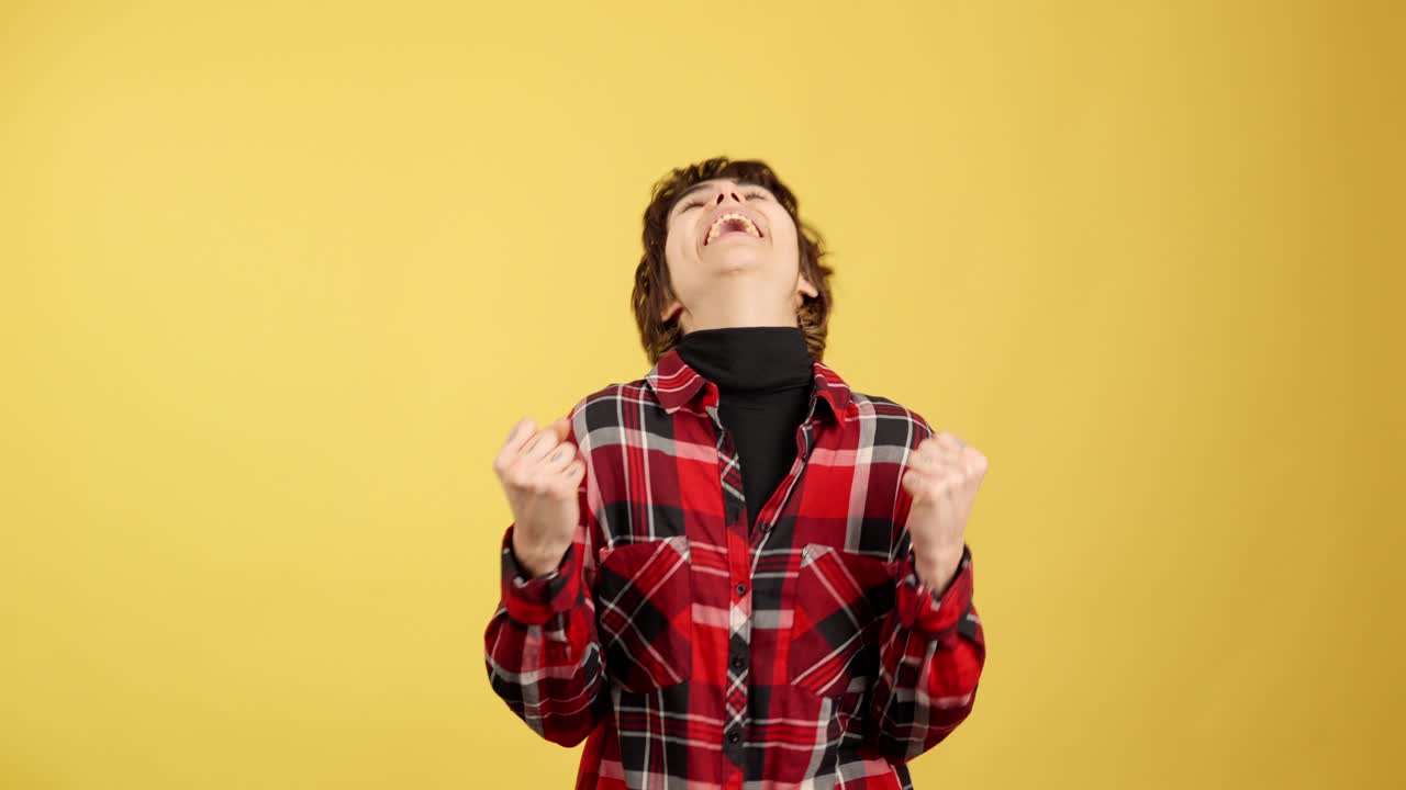 Excited young woman celebrating success with a fist pump