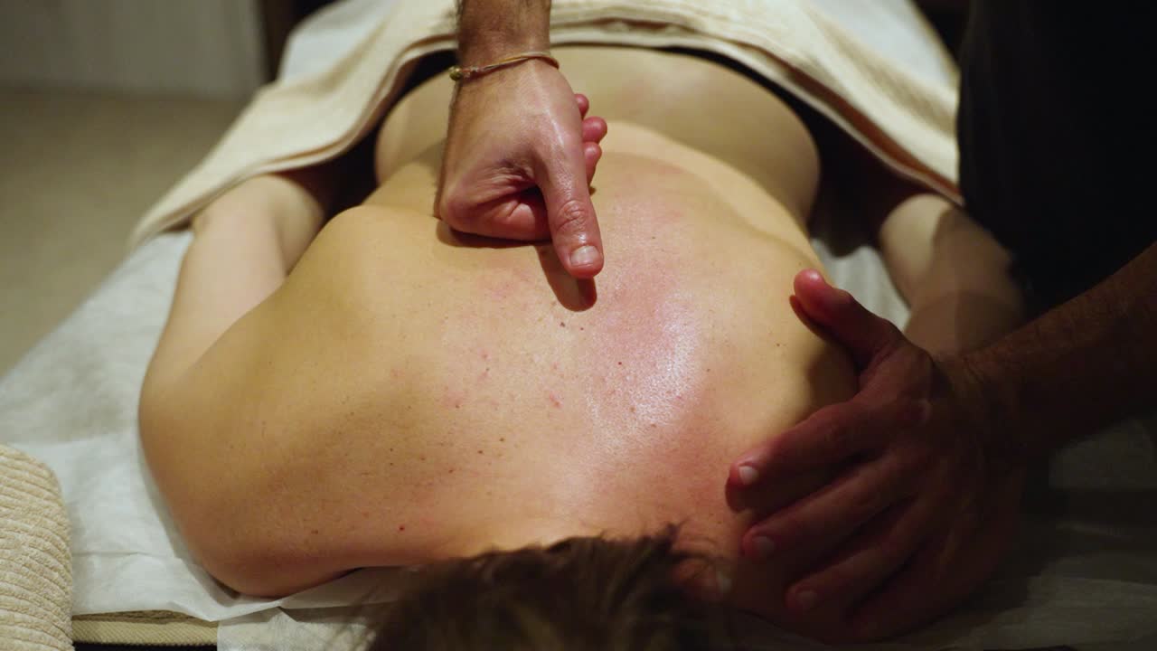 A Masseur is Giving a Back Massage to a Client - Close Up