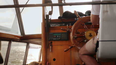 skipper steers small vessel