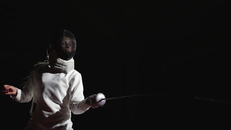 a fencer in action, wearing a mask and holding a sword