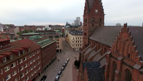 aerial shot of city street and church building in malmö, sweden