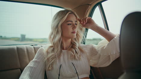 girl travelling car backseat looking window on road close up. woman riding auto.