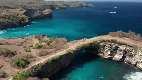 Natural-Arch-and-Lagoon,-Geological-Phenomenon-on-Bali-Sea,-Nusa-Penida-Island,-Indonesia,-Aerial-View