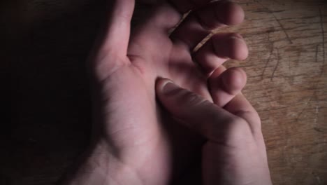 close-up of hand massage technique on wooden surface