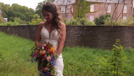 wedding photographer taking photo of beautiful bride in outdoor landscape - medium shot