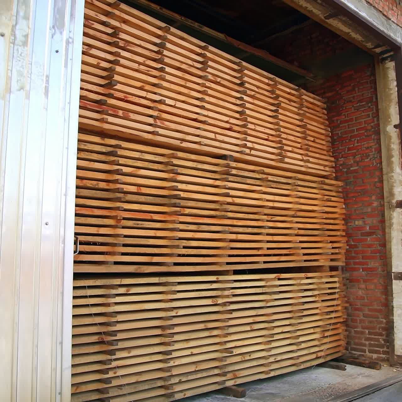 Wooden planks piled in a warehouse up to the top. Timber prepared and stored for modern door production