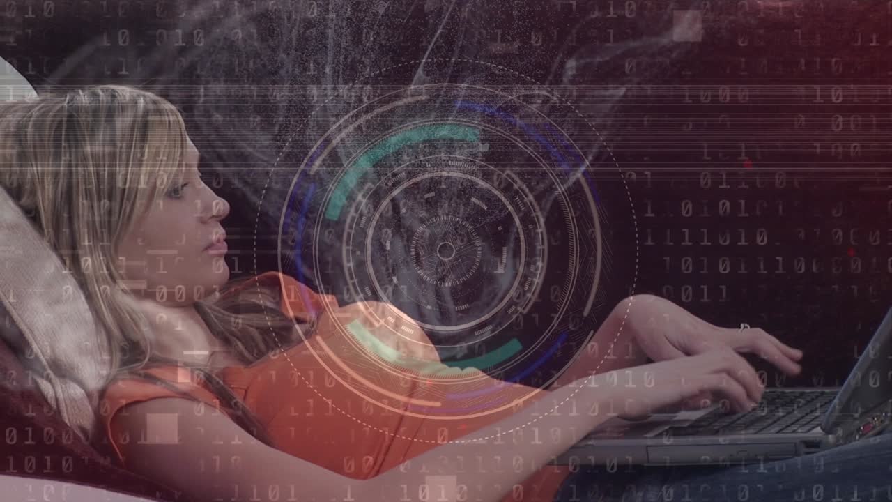 Animation of circles, binary code over caucasian young woman using laptop while lying on sofa