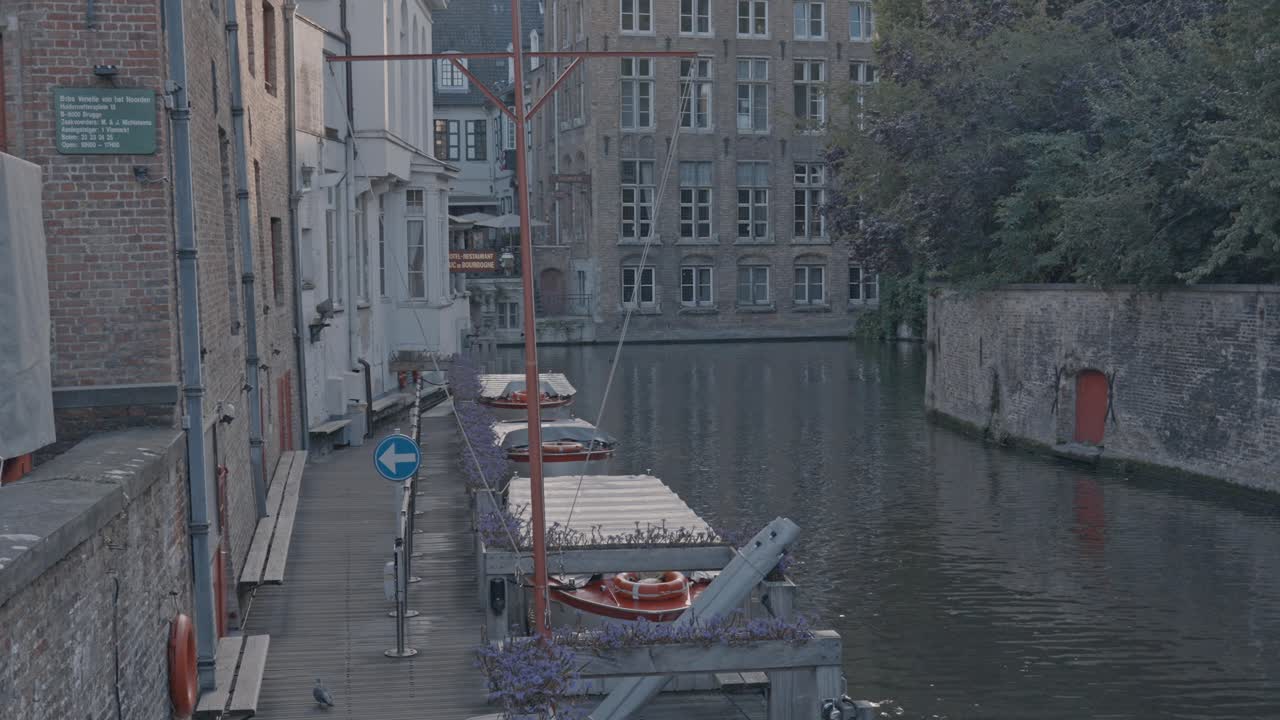 An iconic, picturesque view of the Rozenhoedkaai (Rosary Quay) canal in the medieval city of Bruges, Belgium, captured at sunset or during the golden hour