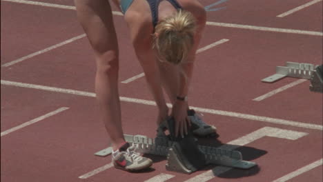 runners prepare their starting blocks