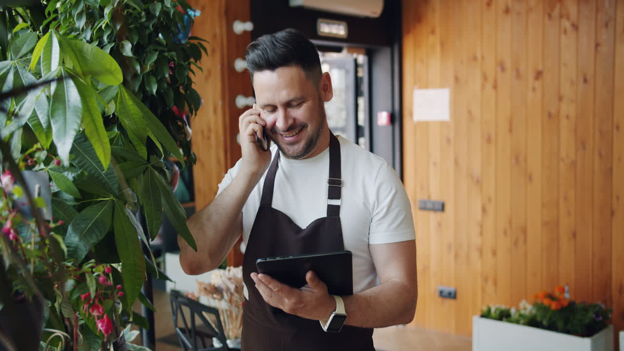Florist Talking on Phone and Using Tablet
