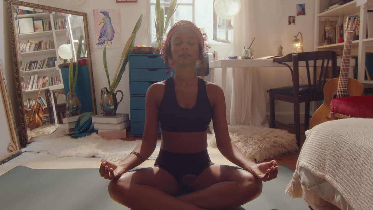 Young African-American Girl Practicing Yoga Meditation at Home