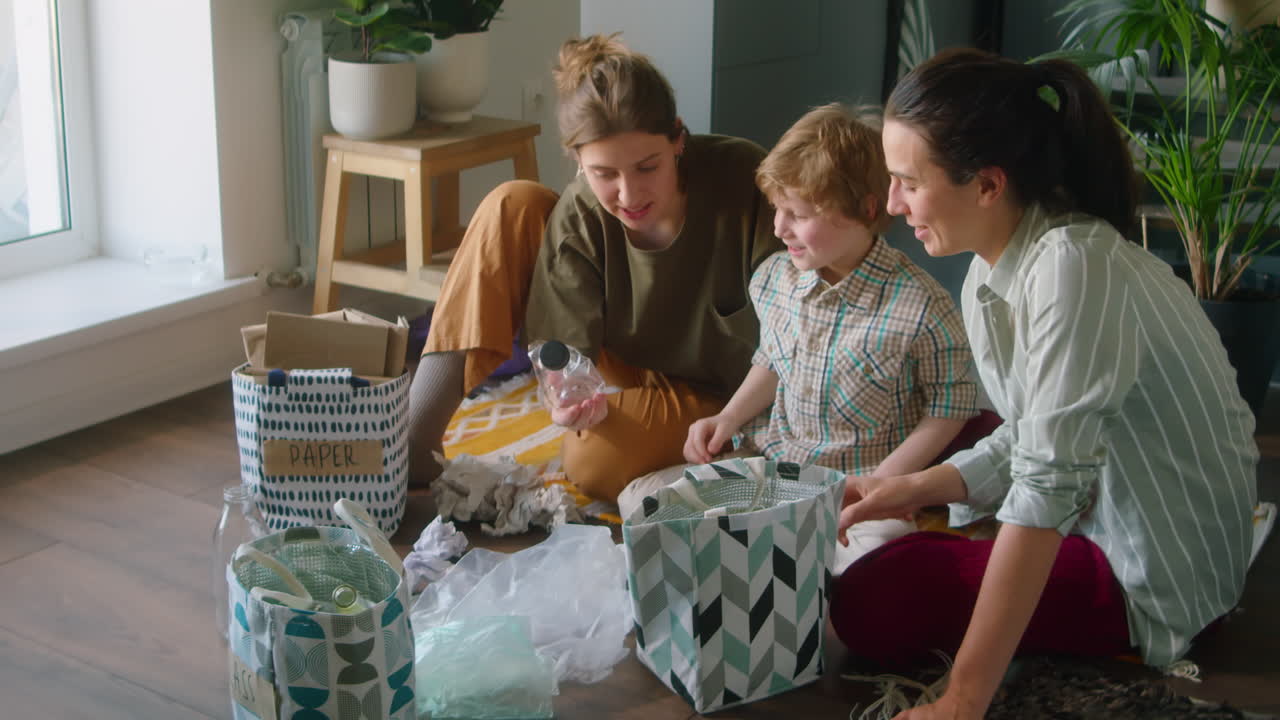 Lesbian Mothers and Little Son Sorting Waste at Home