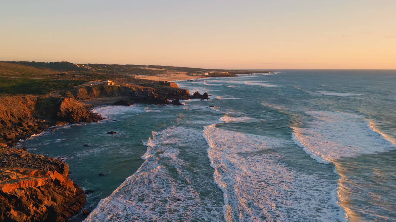Ocean hills evening coastline aerial view. Sunset waves washing volcanic beach