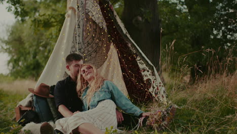 modern rustic couple laughing and smiling while embracing outdoors