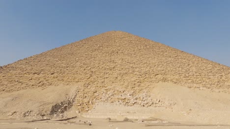 tilt shot in front of the dahshur red pyramid, clear, sunny day in cairo, egypt