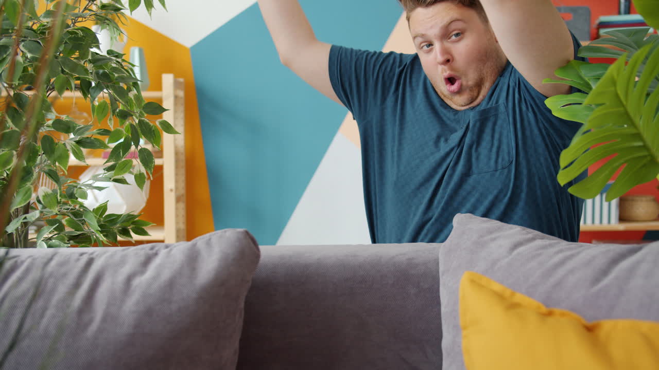 Man frustrated and upset sitting on a sofa