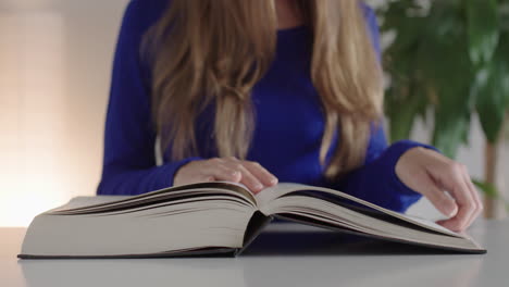 a woman closes a book