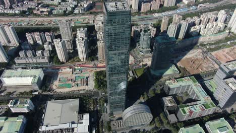 shenzhen financial district skyscraper surrounded by urban buildings, aerial view