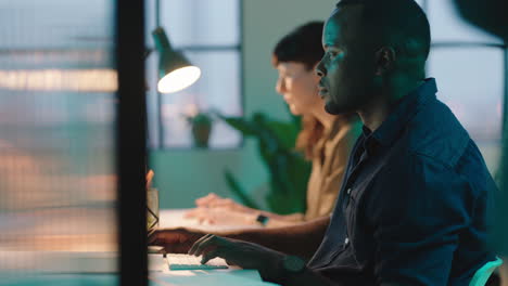 diverse business team working late using computer technology african american businessman developing creative design for company project