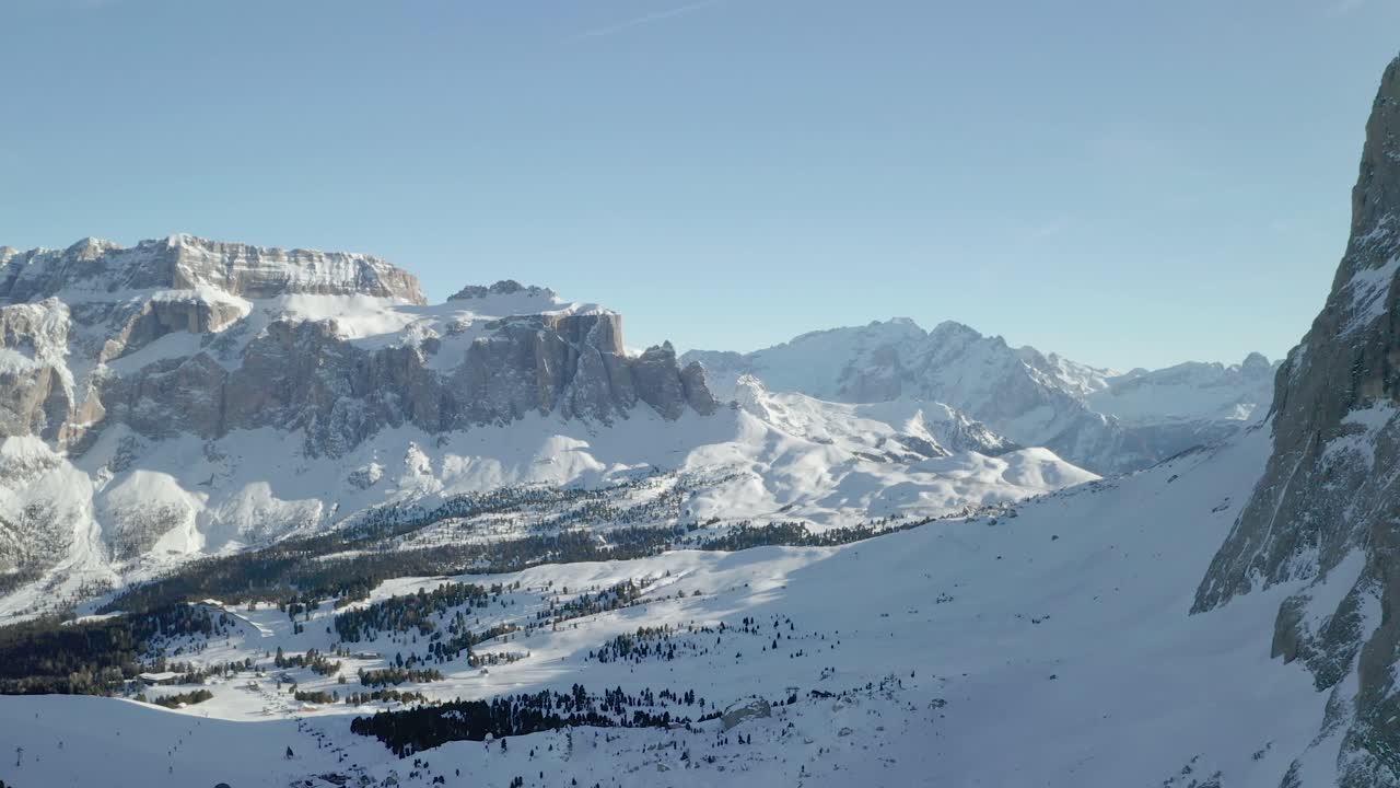 Aerial reveal shot of a ski resort and mountains in Val Gardena in Italian Dolomites