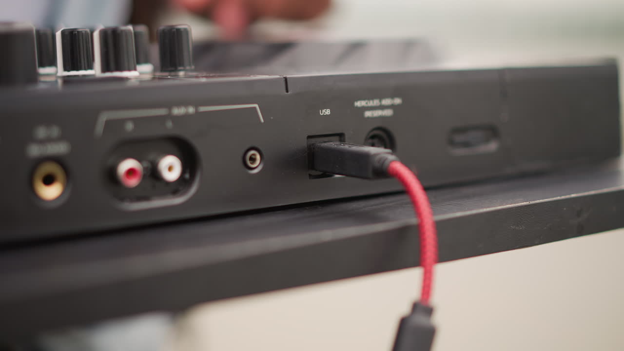 Hand connecting red cable to DJ mixer port, street prep sequence with quick motion, fingers aligning connector across multiple sockets, energetic outdoor vibe, urban equipment ready for live set