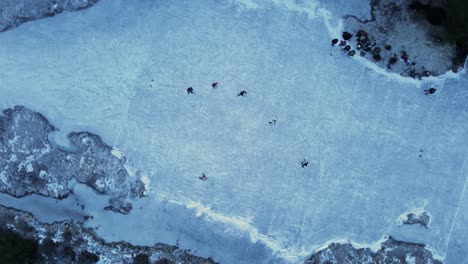 people playing hockey on a frozen lagoon