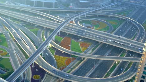 cars driving and travelling in sheikh zayed road on a sunny day in dubai, united arab emirates