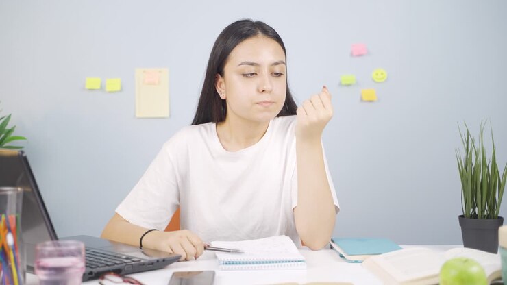 Female student stressed and biting her nails.