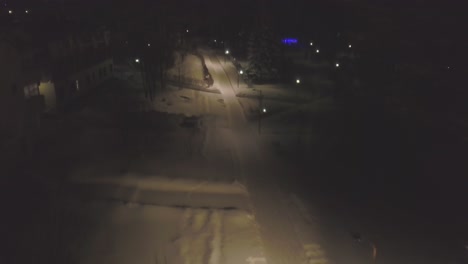 snowy residential street at night