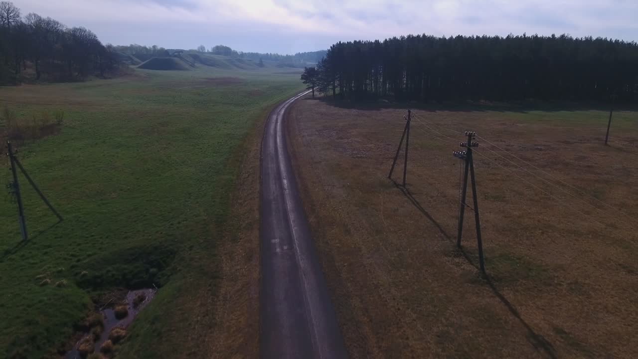 Road through fields and forest