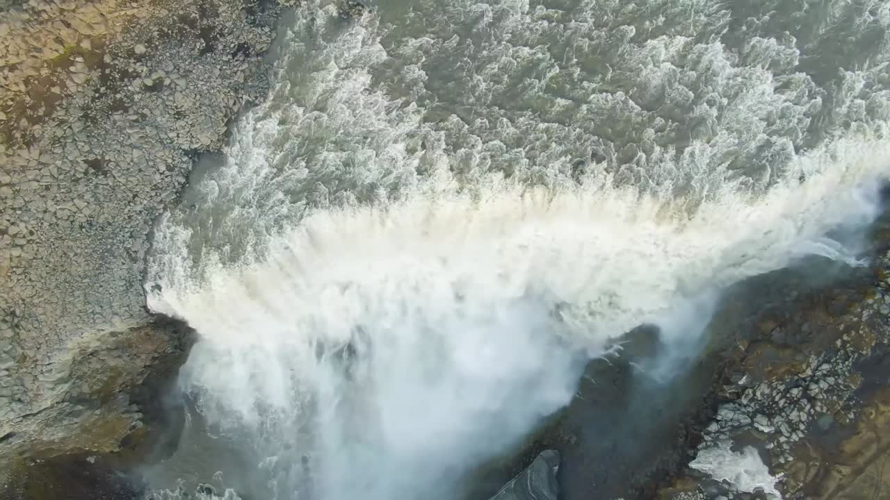 A 4K drone captures a cinematic wide-angle vista of the swiftly cascading Kirkjufellsfoss waterfall in Iceland's picturesque landscape - 2