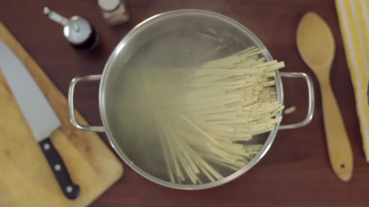 Spaghetti che cuociono in acqua bollente in una pentola