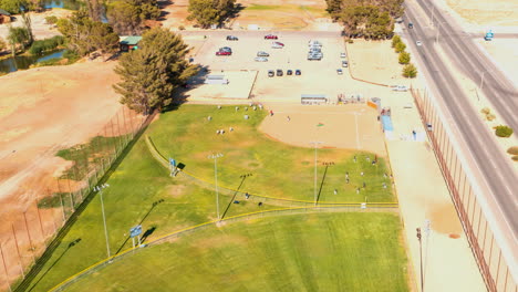 Teams-take-to-the-field-for-a-baseball-game---orbiting-aerial-hyper-lapse