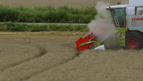 combine harvester harvesting wheat field