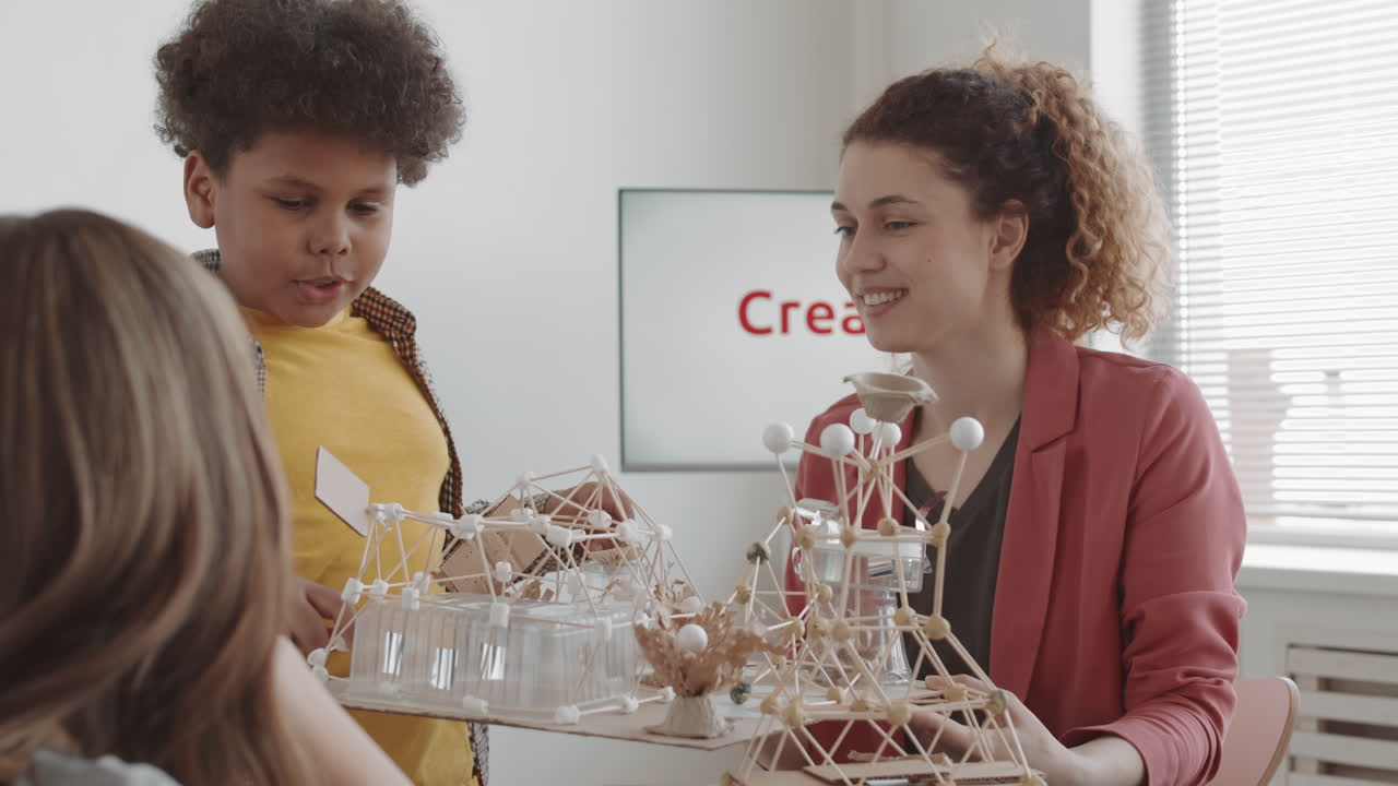 Boy and Teacher Discussing Craft Project