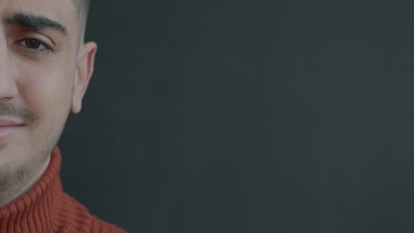 close-up of a man wearing a red sweater