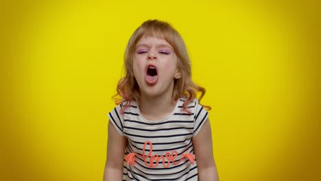child girl showing tongue making faces at camera fooling around joking aping with silly face teasing