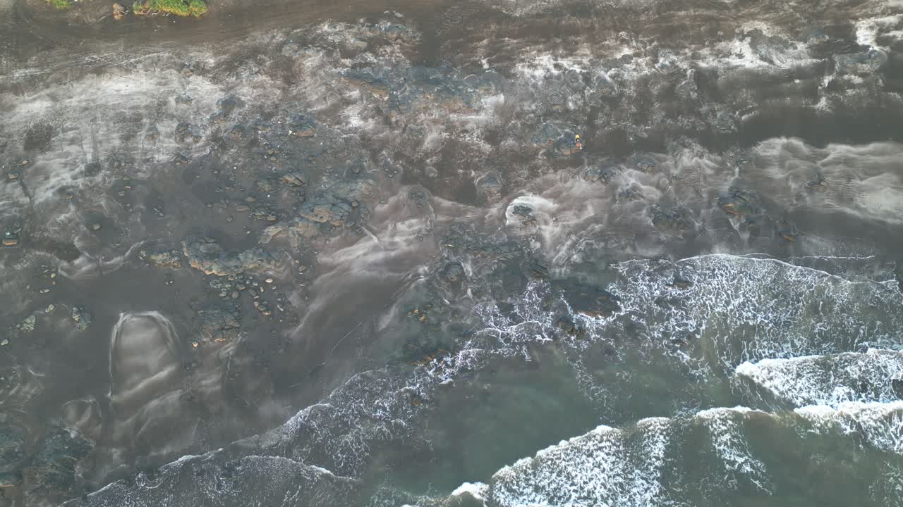Aerial view of waves gracefully rolling onto the peaceful shores of Harihareshwar Beach in Maharashtra, showcasing nature’s serene beauty in perfect harmony 4K