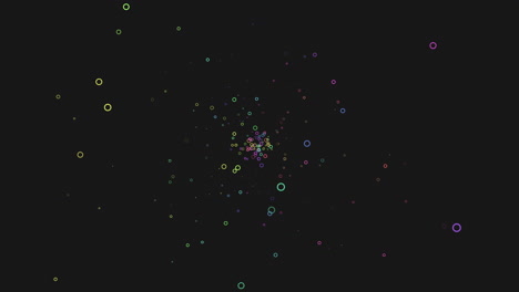 puntos coloridos esparcidos en un fondo negro en un patrón circular