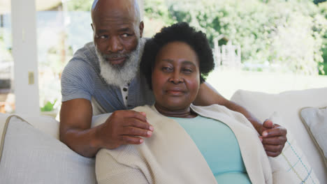 happy senior african american couple embracing and smiling