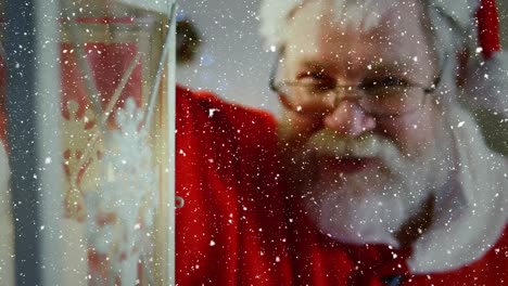composición de video con nieve cayendo sobre santa que sostiene la linterna