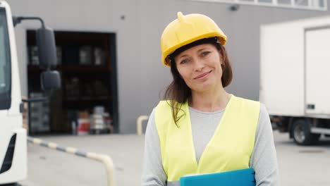 Portrait-of-caucasian-woman-in-front-of-warehouse