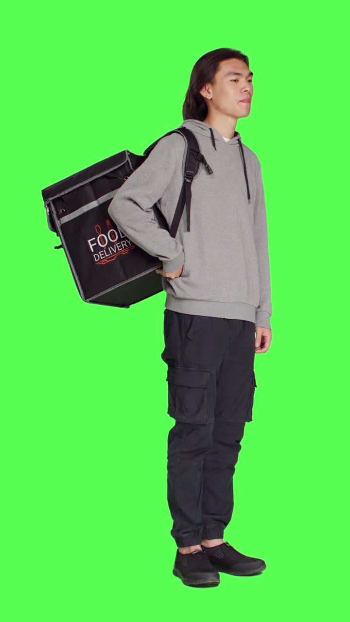 Side view of young man works on food delivery