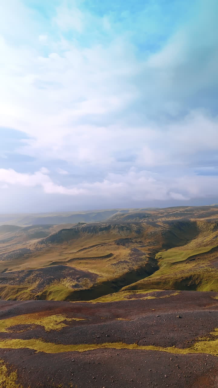 Space landscape of Iceland from top. Rocky scenery of rounded mountains overgrown with mosses. Vertical video.