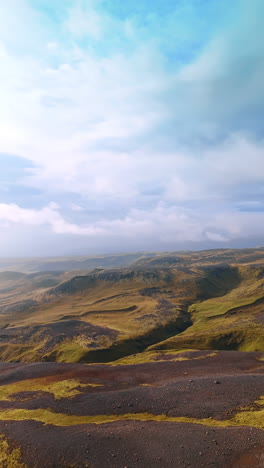 space landscape of iceland from top. rocky scenery of rounded mountains overgrown with mosses. vertical video.
