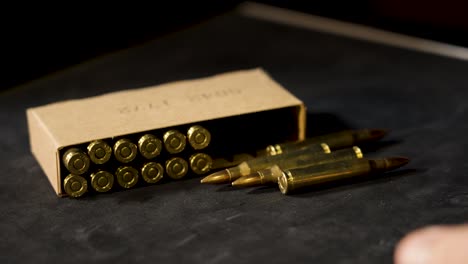 several unfired rounds of 5.56 rolling into frame.
