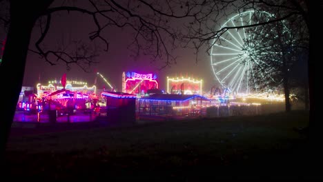 wide static shot of a bright, colourful fairground